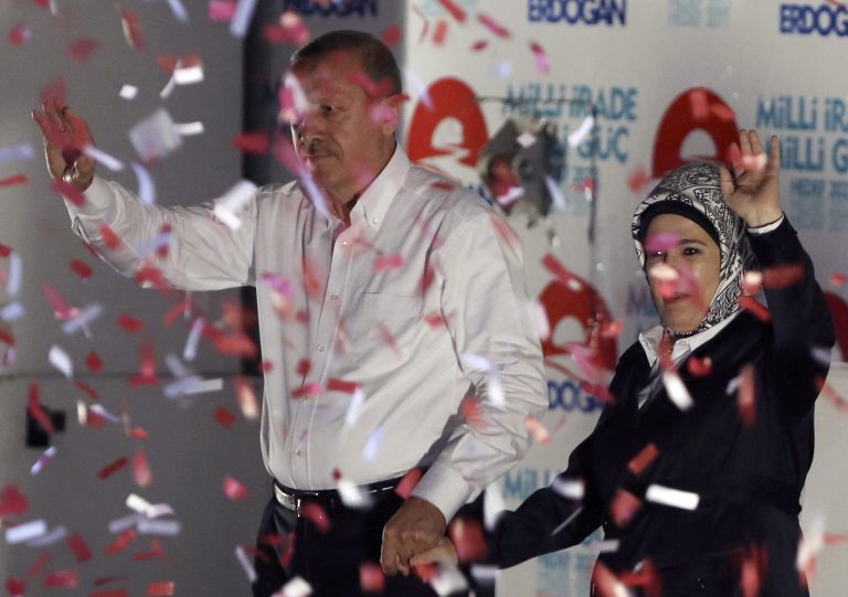 Turkish Prime Minister Recep Tayyip Erdogan and his wife Emine Erdogan wave to supporters after a rally in Ankara, Turkey, Friday, Aug. 8, 2014. Some 53 million Turks go the polls on Sunday to choose their 12th president in an election considered a turning point for the country of 76 million people, with Prime Minister Recep Tayyip Erdogan vying for the position he has pledged to transform from a symbolic role into a position of power. Ekmeleddin Ihsanoglu, the former chief of the Organization of Islamic Cooperation, and Kurdish politician Selahattin Demirtas are also running. (AP Photo/Burhan Ozbilici)