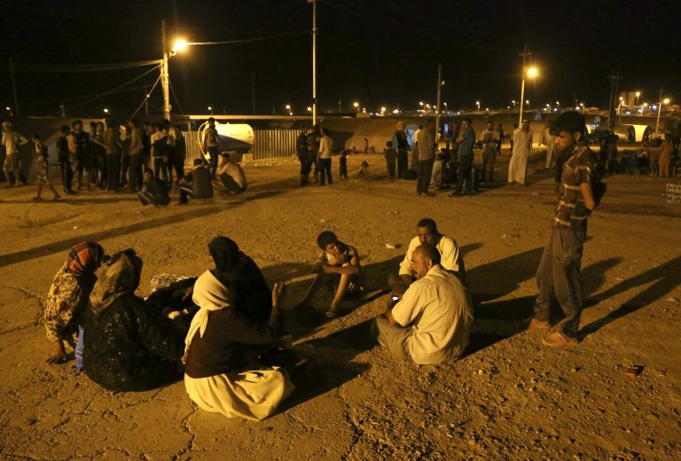 Displaced Iraqis from the Yazidi community settle at the busy camp of Bajid Kandala at Feeshkhabour town near the Syria-Iraq border, Iraq Saturday, Aug. 9, 2014. The displacement of at least tens of thousands of Yazidis Kurdish speakers of an ancient Mesopotamian faith meant yet another Iraqi minority was peeled away as extremists continue their sweep of Iraq, seizing territory they brutally administer. The Islamic State group fighters already caused the expulsion of Iraqâs Christians, Shiite Muslims and adherents of the tiny Shabak faith. The hardliners see other religious groups as heretics who may be killed or forced to submit to their rule. (AP Photo/ Khalid Mohammed)