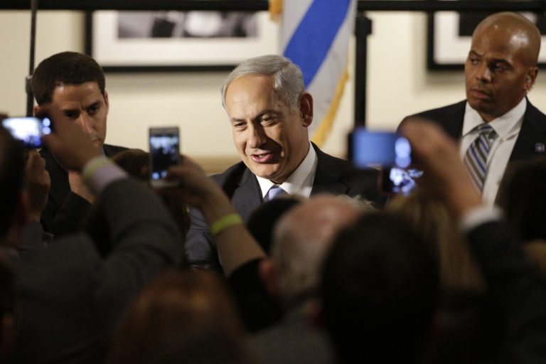 Israeli Prime Minister Benjamin Netanyahu, center, shakes hands with supporters before the screening of the television documentary 