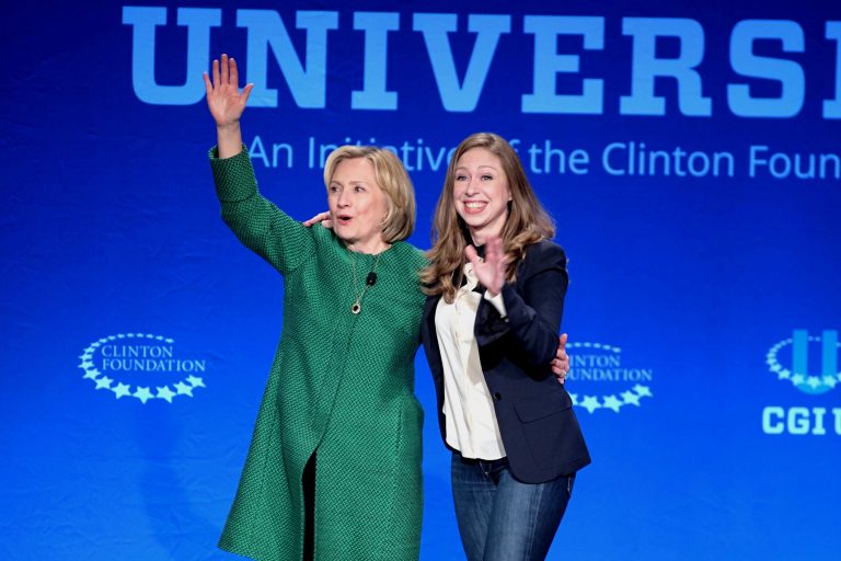 Former Secretary of State Hillary Rodham Clinton, left, and daughter Chelsea Clinton wave at a university conference sponsored by their Clinton Global Initiative at the University of Miami last weekend. (AP Photo/Gaston De Cardenas)