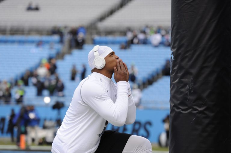 Carolina Panthers quarterback Cam Newton prays before the first half of an NFL divisional playoff football game against the Seattle Seahawks, Sunday, Jan. 17, 2016, in Charlotte, N.C. (AP Photo/Mike McCarn)