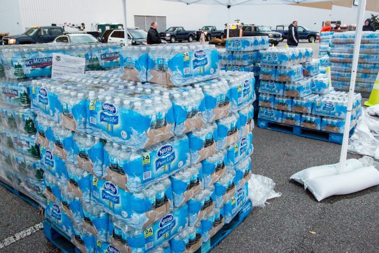 The GeStamp Stamping Plant-South Charleston (W.Va.) is one of several distribution locations open Sunday morning, Jan. 12, 2014 so local residents can pick up bottled water and fill containers after a chemical spill Thursday in the Elk River that has contaminated the public water supply in nine counties. (AP/Michael Switzer)