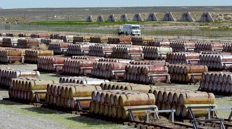 A safety vehicle passes a compound filled with 170-gallon containers of mustard and blister agent at the Deseret Chemical Depot in Tooele, Utah, in 2001. (AP Photo/Douglas C. Pizac, File)