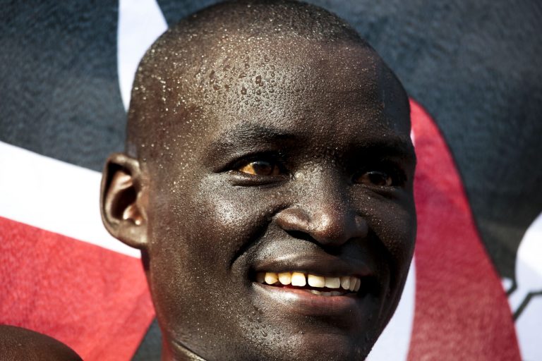 Dennis Kimetto from Kenya smiles after winning the 41st Berlin Marathon in Berlin, Germany,  Sunday, Sept. 28, 2014. Kimetto set a new world record of 2h, 2min and 57sec.(AP Photo/Markus Schreiber)