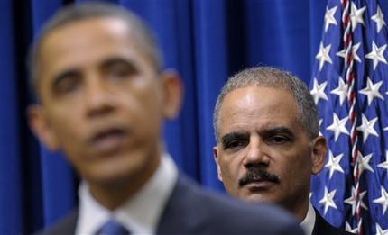In this Feb. 9, 2012 file photo, Attorney General Eric holder listens at right as President Barack Obama speaks about a mortgage settlement in the Eisenhower Executive Office building on the White House complex in Washington. (AP Photo/Susan Walsh)
