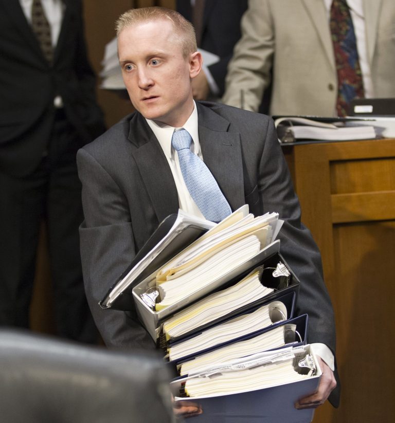 FILE - This May 20, 2013, file photo shows Stephen Tausend, counsel for Senate Judiciary Committee member John Cornyn, R-Texas, arriving for the committee's hearing on the landmark immigration bill with documents related to the panel's work, on Capitol Hill in Washington. The immigration bill may sound simple because a bipartisan group of eight senators drafted it; the White House, organized labor and the Chamber of Commerce all support it; and many Republican political strategists want to show a more welcoming face to Hispanic voters. But simple it won't be. (AP Photo/J. Scott Applewhite, File)