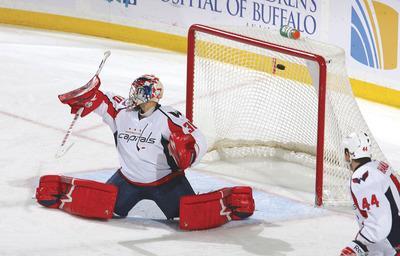 Rick Stewart/Getty Images
Caps goalie Michal Neuvirth allowed three goals in the first 11:15 before he was pulled in Monday's loss to the Sabres.