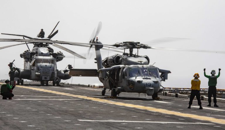 On March 6, 2019 sailors perform pre-flight checks on an MH-60S Sea Hawk helicopter on the flight deck of the Wasp-class amphibious assault ship USS Kearsarge (LHD 3). 