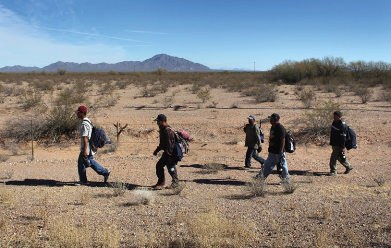 Undocumented Mexican immigrants walk through the Sonoran Desert after illegally crossing the U.S.-Mexico border border into the Tohono O'odham Nation, Arizona. (John Moore/Getty Images)