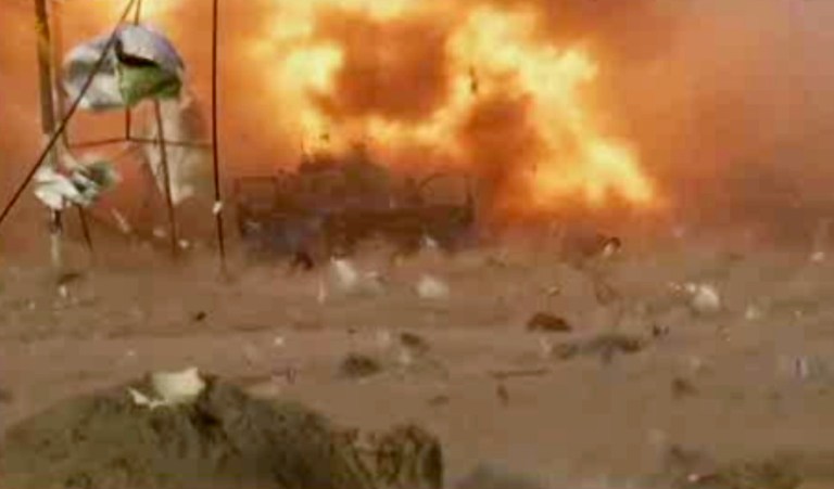 This image made from video shows a car bomb at the moment of impact, one in a series of bombs that exploded Friday, April 25, 2014 at a campaign rally for a Shiite group in  Baghdad, Iraq, ahead of the country's parliamentary election. The blasts killed and wounded dozens, officials said. (AP Photo via AP video)