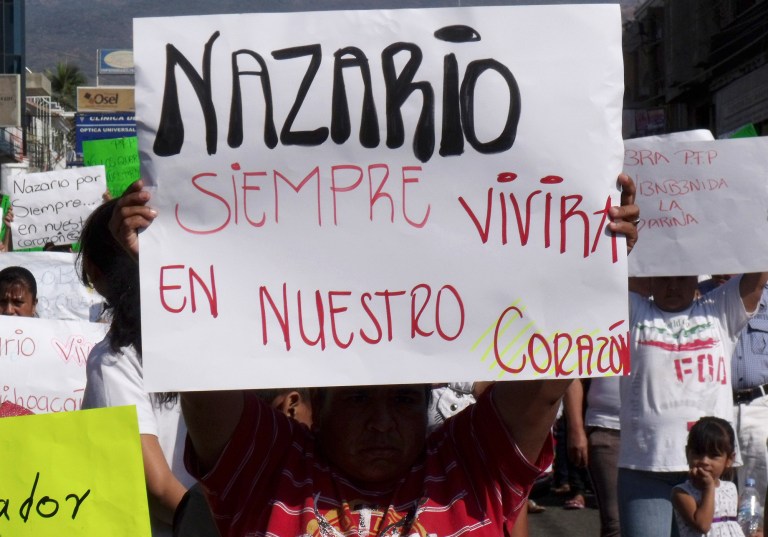 FILE - In this Dec. 12, 2010 file photo, a man holds a sign that reads in Spanish 