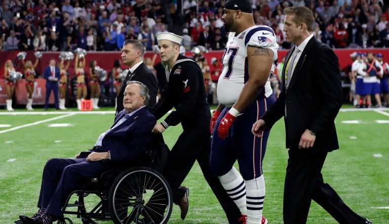 Former President George H.W. Bush is escorted onto the field before the NFL Super Bowl 51 football game between the New England Patriots and the Atlanta Falcons Sunday, Feb. 5, 2017, in Houston. (AP Photo/Matt Slocum)