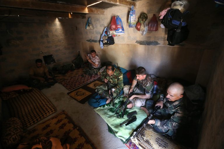 Kurdish peshmerga fighters clean their weapons at a base on the closet front line with militants from the al-Qaida-inspired Islamic State in Iraq and the Levant (ISIL), in Tuz Khormato, 100 kilometers (62 miles) south of the oil rich province of Kirkuk, northern Iraq, Wednesday, June 25, 2014. A defiant Prime Minister Nouri al-Maliki rejected calls Wednesday for an interim 