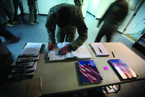 A U.S member of Combined Joint Task Force-101 filling out voter absentee ballot at a US military base in Bagram north of Kabul, Afghanistan. (AP Photo/Rafiq Maqbool)