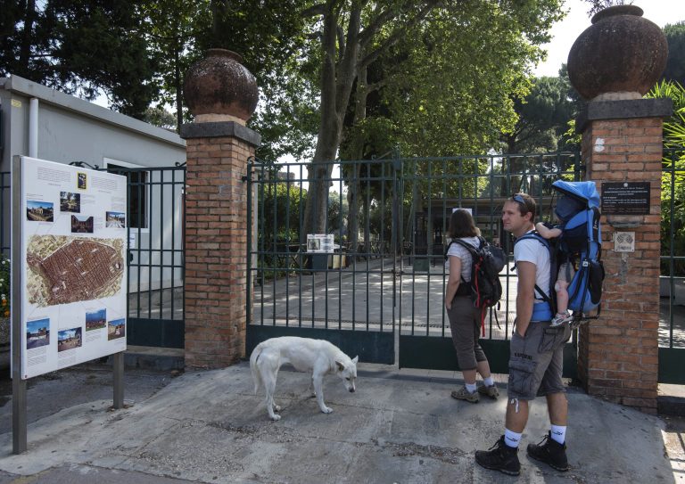 Visitors wait in front of one of Pompeii gates, Italy, Monday, June 23, 2014. A labor dispute kept tourists locked out of Pompeii for part of Monday, the latest in a spate of hours-long closures at the ancient Roman ruins. The gates were unlocked a couple of hours late, frustrating tourists wanting to enter the sprawling ruins in early morning. The dispute over work schedules and back pay began last week, keeping thousands of visitors shut out for hours at a time during union meetings. The government office that runs Pompeii said that three assemblies planned later this week were canceled, meaning visitors could expect regular opening hours. (AP Photo/Salvatore Laporta)