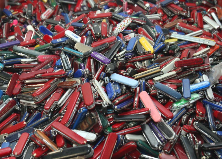 FILE - In this Sept. 26, 2006, file photo, knives of all sizes and types are piled in a box at the State of Georgia Surplus Property Division store in Tucker, Ga., and are just a few of the hundreds of items discarded at the security checkpoints of Hartsfield-Jackson Atlanta International Airport that will be for sale at the store. Airline passengers will be able to carry small knives, souvenir baseball bats, golf clubs and other sports equipment onto planes beginning in April 2013 under a policy change announced Tuesday, March 5, 2013, by the head of the Transportation Security Administration administrator John Pistole. (AP Photo/Gene Blythe, File)