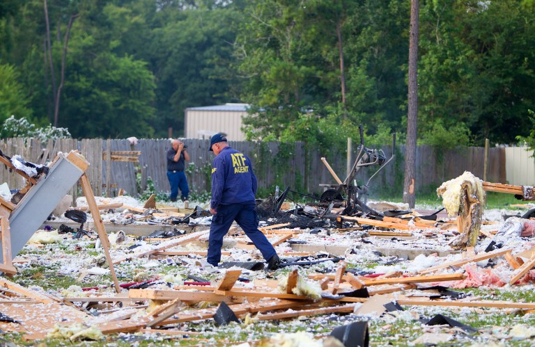 Investigators work the scene of an explosion, Tuesday, July 22, 2014, in Willis, Texas. Three people were seriously injured when a house exploded early Tuesday morning in north Montgomery County. The incident happened about 5 a.m. on Mandy Lane near Rogers in the Willis area, according to the Montgomery Fire Marshal's Office. Three adults were flown by LifeFlight medical helicopter to Memorial Hermann-The Texas Medical Center. Details of their injuries were not released, but they were in critical condition, said Jason Oliphant, chief of Montgomery County Emergency Services District No. 1. Oliphant said the home was totally destroyed and small fires burned after the explosion. He said it was unclear what sparked the blast. (AP Photo/Houston Chronicle, Cody Duty)