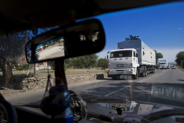Trucks move towards a border control point with Ukraine in the Russian town of Donetsk, Rostov-on-Don region, on Friday. The first trucks of the Russian aid convoy crossed the Ukrainian inspection zone Friday morning. (AP Photo/Pavel Golovkin)