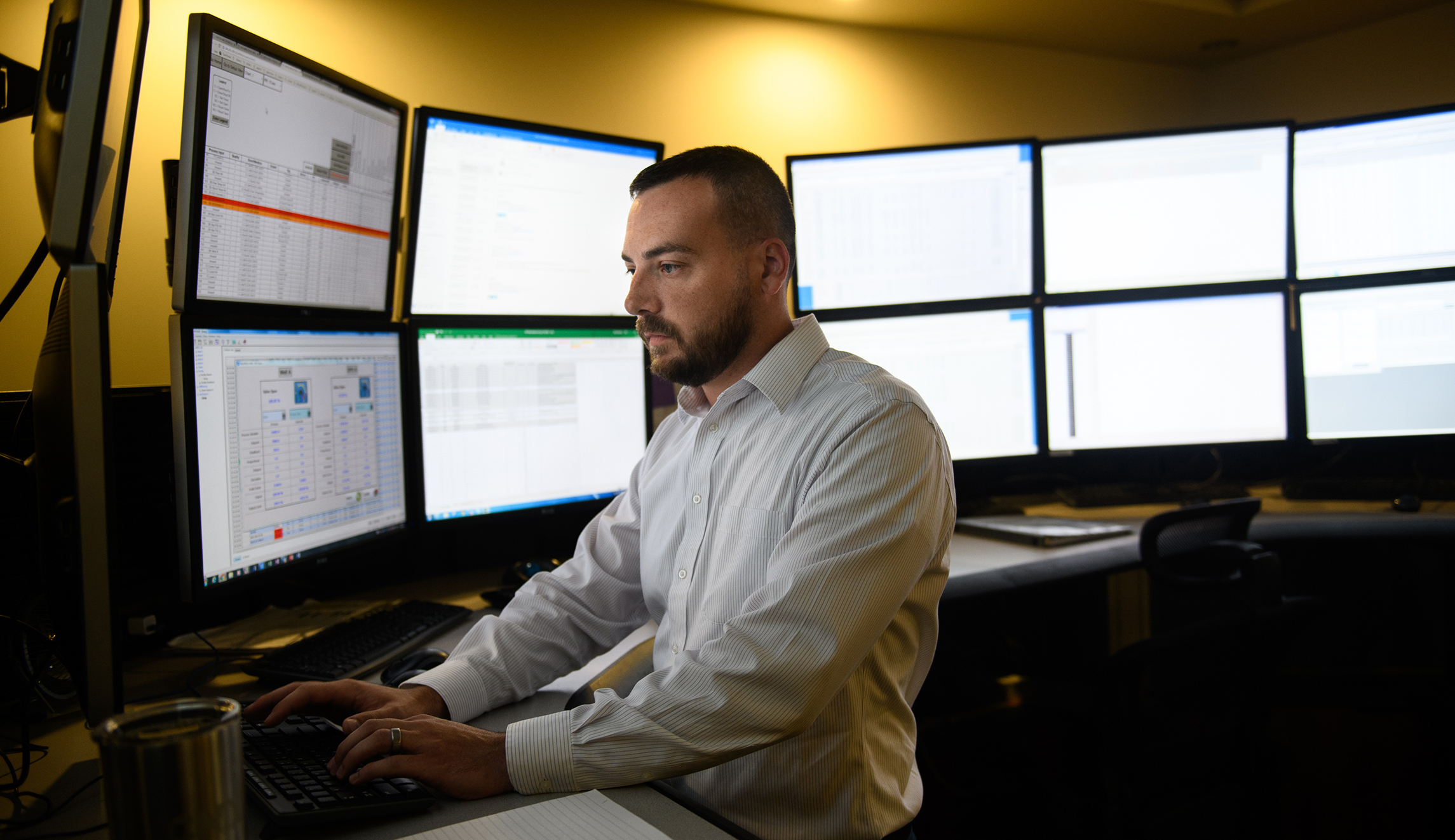 Mike May, 33, of Oakdale, Pa., works in the control room of CNX Resources Corporation on July 30 at their headquarters in Cannonsburg, Pa. The control room is able to monitor and adjust well sites throughout several states.