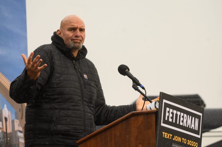 John Fetterman, lieutenant governor of Pennsylvania and Democratic Senate candidate, speaks as heavy rains fall during a campaign rally in Pittsburgh, Pennsylvania, on Oct. 1.