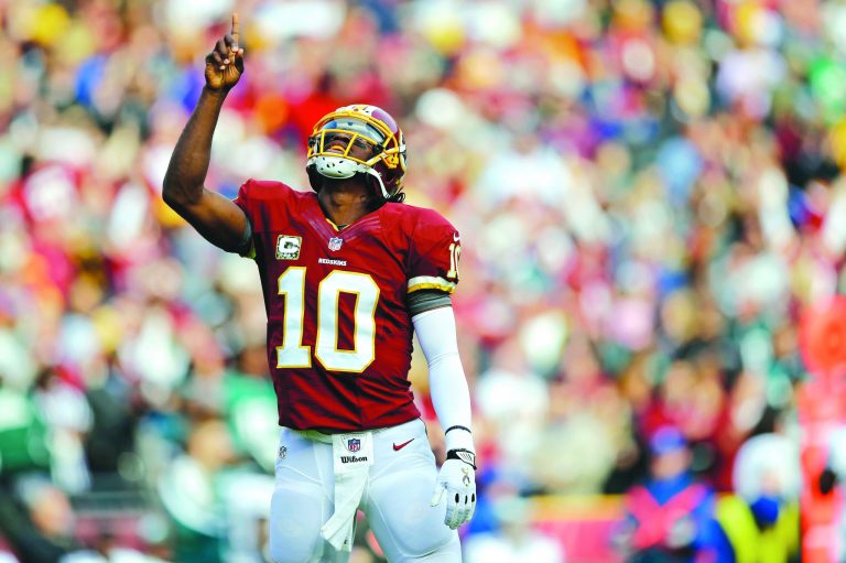 Patrick Semansky/AP
Robert Griffin III threw four touchdown passes and finished with a perfect 158.3 rating as the Redskins blew out the Eagles on Sunday.
