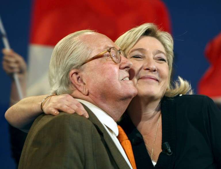 FILE -  This Sunday, March 4, 2012, file photo shows honorary President of  far-right  party National Front Jean-Marie Le Pen, left, and his daughter French far-right leader and National Front Party candidate for the 2012 French presidential elections, Marine Le Pen, during a campaign meeting in Marseille, southern France. A Greek tragedy is playing out in the House of Le Pen, the seat of France's rising far right, with the wounded patriarch lashing out at his daughter, his political heir, in a feud over an anti-Semitic smear that goes to the heart of her efforts broaden the party's support.(AP Photo/Claude Paris)