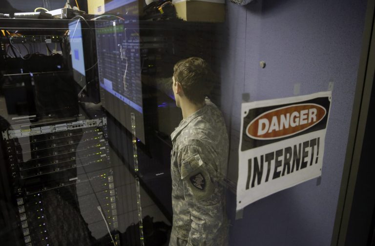 A United States Military Academy cadet checks computers at the Cyber Research Center at the United States Military Academy in West Point, N.Y., Wednesday, April 9, 2014. The West Point cadets are fending off cyber attacks this week as part of an exercise involving all the service academies. The annual Cyber Defense Exercise requires teams from the five service academies to create computer networks that can withstand attacks from the National Security Agency and the Department of Defense. (AP Photo/Mel Evans)