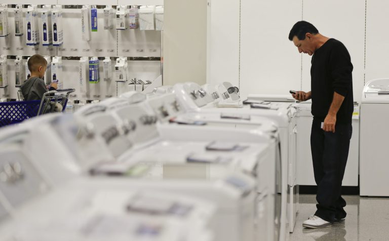   In this Friday, Nov. 23, 2012, photo, a man examines a row of washers and dryers while shopping at a Sears store in Henderson, Nev. U.S. companies increased their orders for long-lasting manufactured goods in November, with a second consecutive monthly gain in a key category that reflects businessesâ investment plans. The Commerce Department reported Friday, Dec. 21, 2012, that orders for durable goods rose a seasonally adjusted 0.7 percent in November, compared to October, when orders had risen 1.1 percent. (AP Photo/Julie Jacobson)  