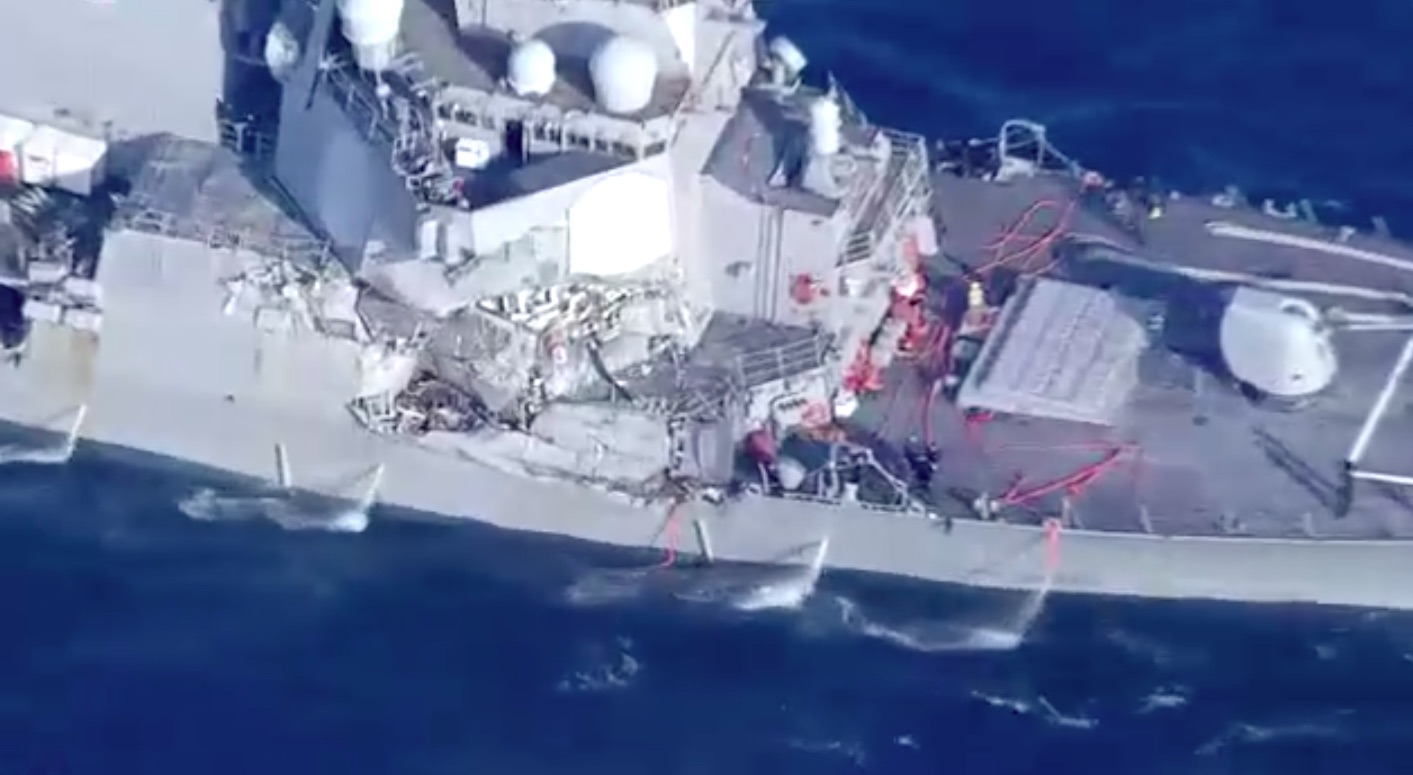 Search continues for 7 missing sailors as damaged Navy destroyer returns to port