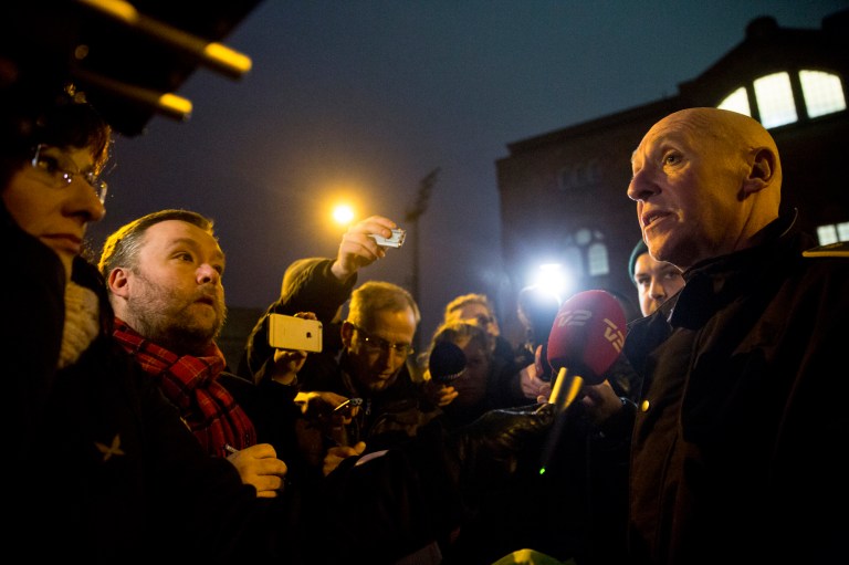 A police inspector, right, speaks during a press conference, after shots were fired where an event titled 