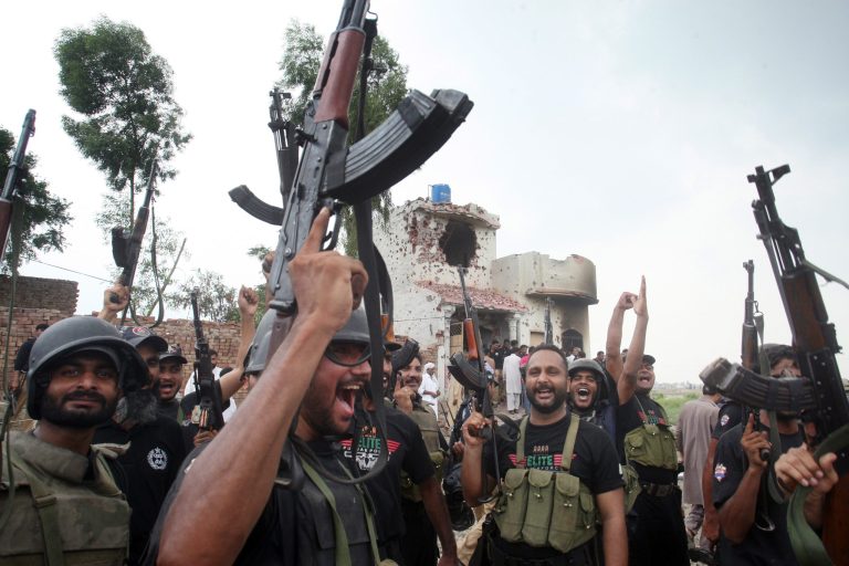 Pakistani police commandos celebrate a successful operation against terrorists in Lahore, Pakistan, Thursday, July 17, 2014. Officials said police fought for more than 10 hours with militants planning to attack the prime minister's home in eastern Pakistan. (AP Photo/K.M. Chaudary)