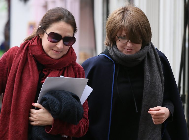 Russian oligarch Boris Berezovsky's daughters Elizaveta, right and Ekatrina arrive for the second day of the inquest into his death at Windsor Coroner's Court, in Windsor, England,  Thursday, March, 27, 2014. Elizaveta Berezovsky is due to appear as a witness on the second day of the hearing into the death of the tycoon.  He was found dead at his former wife's property,  in March 2013. (AP Photo/Alastair Grant)