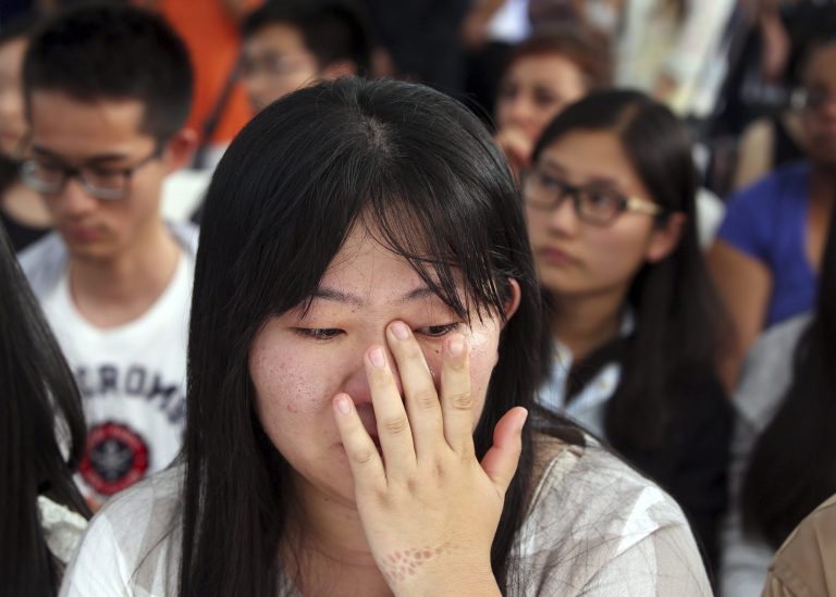 A mourner cries during a memorial service for slain Chinese student Xinran Ji at the University of Southern California in Los Angeles on Friday, Aug. 1, 2014. Prosecutors say Ji was fatally beaten with a bat while walking home from a study group on July 24. In a statement, Ji's parents, Songbo Ji and Jinhui Du, say they're concerned about the safety of other USC students, adding: 