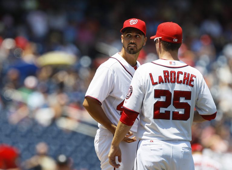 Washington Nationals starting pitcher Gio Gonzalez talks on the mound with first baseman Adam LaRoche (25)  during the third inning of a baseball game against the New York Mets on Thursday, July 19, 2012, in Washington. (AP Photo/Carolyn Kaster)