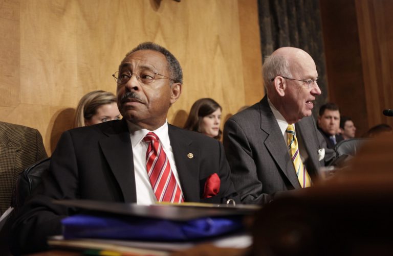 FILE - In this Wednesday, Jan. 20, 2010, file photo, Senate Homeland Security and Governmental Affairs Committee member Sen. Roland Burris, D-Ill., left, sits next to fellow member Sen. Robert Bennett, R-Utah, on Capitol Hill in Washington. Allegations against Burris, 77, who held a Senate seat from 2009 to 2010, arose during a pre-trial hearing Friday, Sept. 26, 2014, for a Chicago man charged with illegally lobbying U.S. lawmakers to lift sanctions against Zimbabwean President Robert Mugabe. (AP Photo/Pablo Martinez Monsivais, File)
