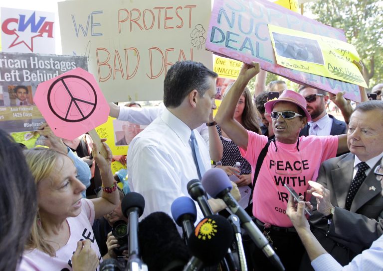 Republican presidential candidate, Sen. Ted Cruz talks to a Code Pink anti-war group member. (AP Photo/Luis M. Alvarez)