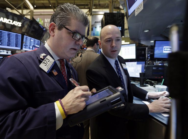 Trader John Panin, left, and specialist Jay Woods work on the floor of the New York Stock Exchange Tuesday, Jan. 28, 2014. Stocks are higher in early trading on Wall Street as the stock market turns positive after three days of losses. (AP Photo/Richard Drew)
