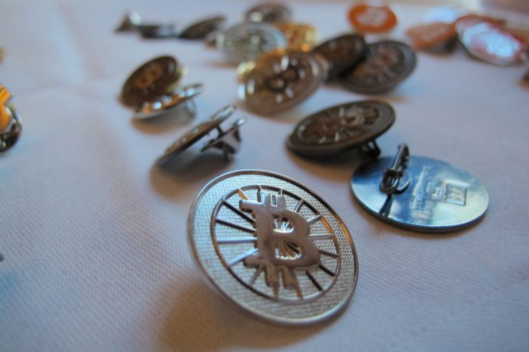 Bitcoin buttons are displayed on a table at the Inside Bitcoins conference in Berlin on Wednesday, Feb. 12, 2014. The conference brought together entrepreneurs and enthusiasts of the virtual currency to discuss business opportunities and recent developments. (AP Photo/Frank Jordans)