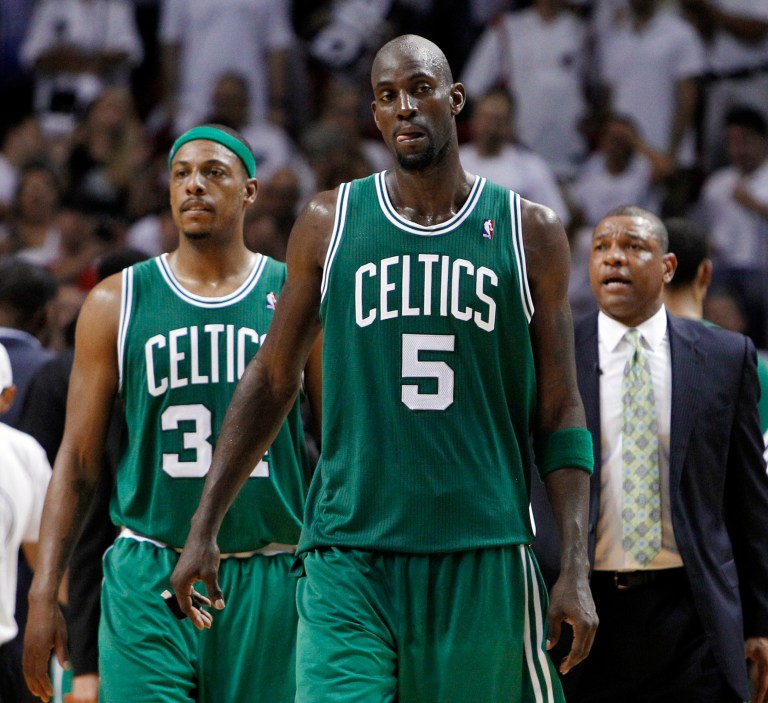   Boston Celtics' Kevin Garnett (5) and Paul Pierce walk up the court as coach Doc Rivers watches during the final minutes of Game 7 of the NBA basketball playoffs Eastern Conference finals against the Miami Heat, Saturday, June 9, 2012, in Miami. The Heat defeated the Celtics 101-88. (AP Photo/Lynne Sladky)  