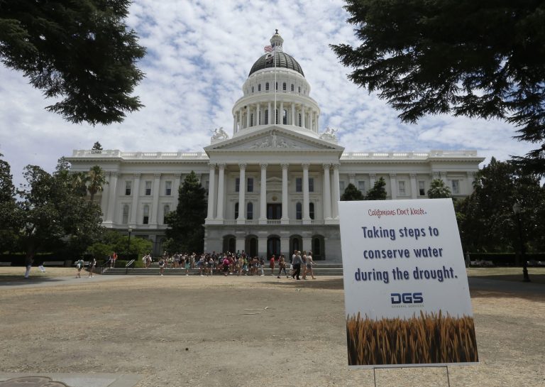 A sign alerts visitors to water conservation efforts at the state Capitol, Tuesday, July 8, 2014, in Sacramento, Calif.  State water regulators are considering fines up to $500 for excessive water use for things like irrigating lawns and car washing due to the state's severe drought. (AP Photo/Rich Pedroncelli)
