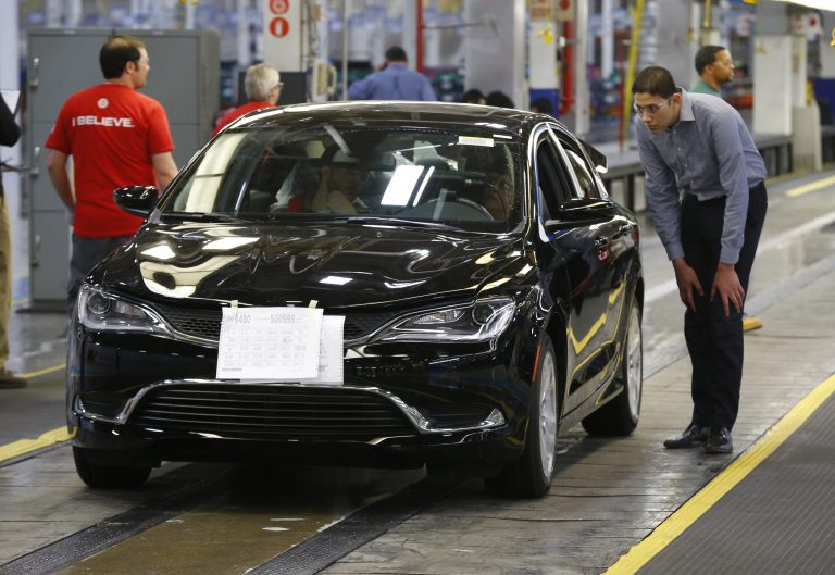 FILE - In this March 14, 2014 file photo, a 2015 Chrysler 200 automobile rolls down the assembly line at the Sterling Heights Assembly Plant in Sterling Heights, Mich. The major automakers release sales for September on Wednesday, Oct. 1, 2014. (AP Photo/Paul Sancya, File)