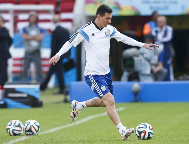 Argentina's Lionel Messi, right, kicks a ball  during a training session at the Beira-Rio Stadium in Porto Alegre, Brazil, Tuesday, June 24, 2014.  Argentina plays in group F of the 2014 soccer World Cup. (AP Photo/Victor R. Caivano)