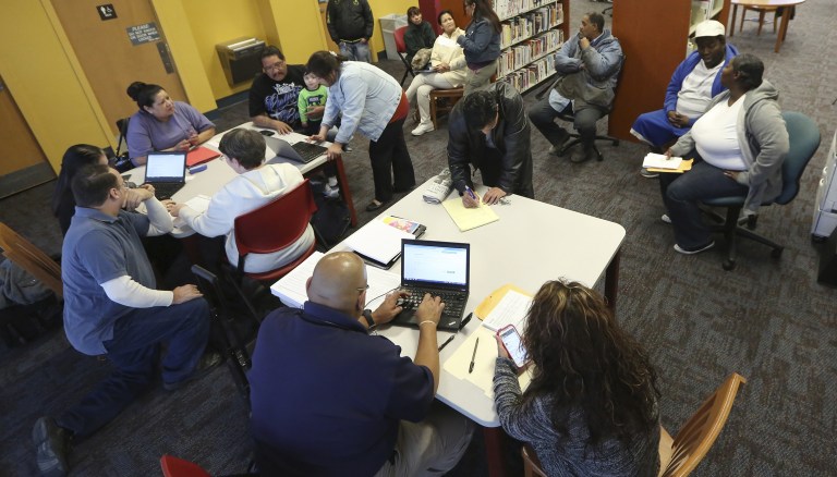 Double-digit shares of enrollees in states with and without Medicaid expansion had problems paying bills. (AP Photo/LM Otero, File)