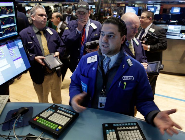 FILE- In this Wednesday, Feb. 5, 2014, file photo, Specialist Ronnie Howard, foreground, works at the post that trades CVS Carremark, on the floor of the New York Stock Exchange. Australia's stock market and currency jumped Thursday Feb. 6, 2014 after encouraging economic data while gains on other major world benchmarks were more modest as investors waited for key policy meetings in Europe and a major U.S. job report.  (AP Photo/Richard Drew, File)