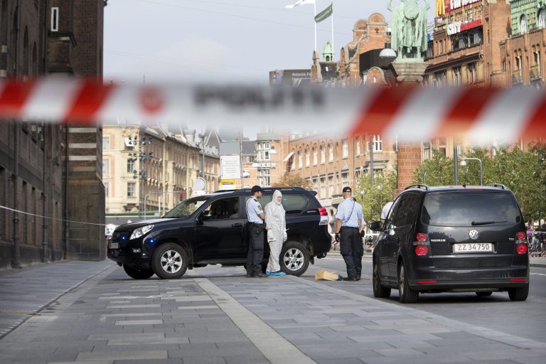 Police are seen outside Town Hall Square, Raadhuspladsen, in Copenhagen on Tuesday, Sept. 16, 2014. Police say shots have been fired inside a court building in the capital Copenhagen, killing one person and seriously wounding a second. In a statement Tuesday, police say a suspect has been arrested and a shotgun has been seized. There was no information on the victims or the suspect. The shooting happened just before 10 a.m. at the Bailiff's court, behind the city hall. (AP Photo/Finn Frandsen, POLFOTO) DENMARK OUT