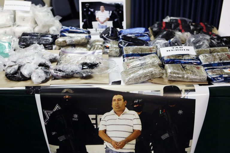 Mexican tar heroin and methamphetamine are displayed as evidence during a news conference at the sheriff's department jail annex in Ventura, Calif. (AP File Photo/Damian Dovarganes)