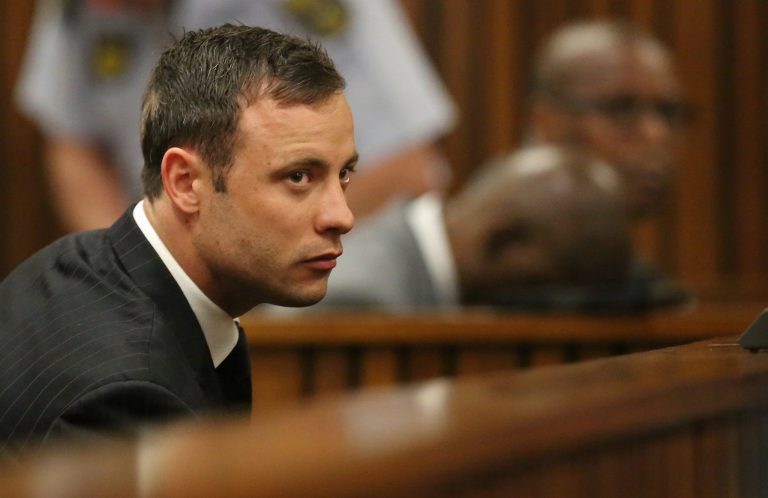Oscar Pistorius sits in the dock looking in court in Pretoria, South Africa, Friday, Sept. 12, 2014.  Judge Thokozile Masipa found Pistorius guilty of culpable homicide for the shooting death of his girlfriend Reeva Steenkamp. Sentencing procedures will start Oct. 13. (AP Photo/Siphiwe Sibeko, Pool)