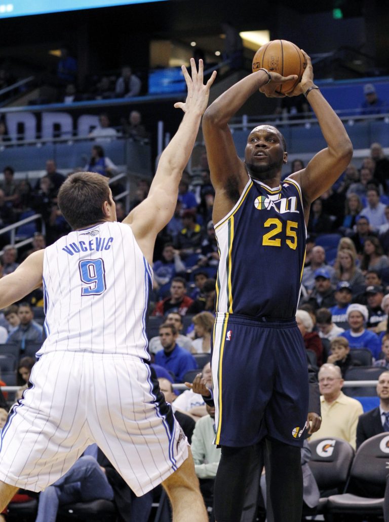   Utah Jazz center Al Jefferson (25) shoots over Orlando Magic center Nikola Vucevic (9) during the first half of an NBA basketball game, Sunday, Dec. 23, 2012, in Orlando, Fla. (AP Photo/Scott Iskowitz)  
