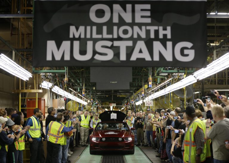   FILE - In this Wednesday, April 17, 2013, file photo, Ford's Flat Rock Assembly Plant employees cheer as the millionth Ford Mustang is driven off the assembly line in Flat Rock, Mich. The government issues its second estimate of worker productivity and labor costs for the April-June quarter on Thursday, Sept. 5, 2013. (AP Photo/Carlos Osorio, File)  