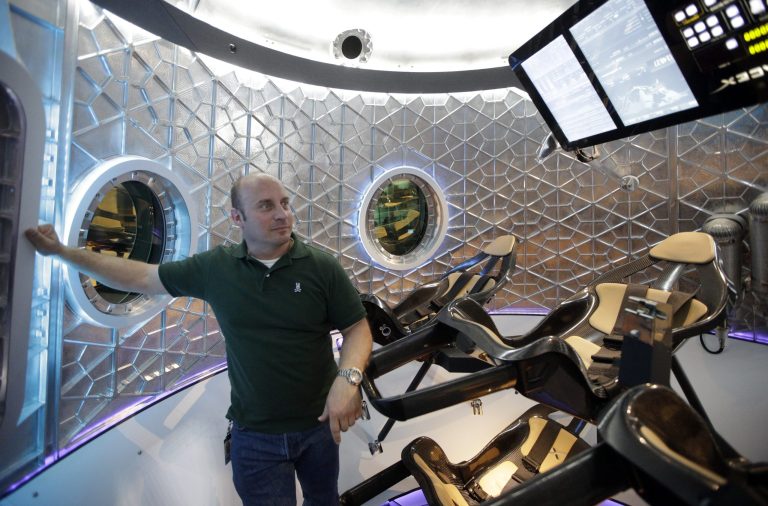 Garrett Reisman, program lead for crew vehicles of the SpaceX, stands inside the SpaceX Dragon V2 at the headquarters on Thursday, May 29, 2014, in Hawthorne, Calif. SpaceX, which has flown unmanned cargo capsules to the International Space Station, unveiled the new spacecraft Thursday designed to ferry astronauts to low-Earth orbit. (AP Photo/Jae C. Hong)